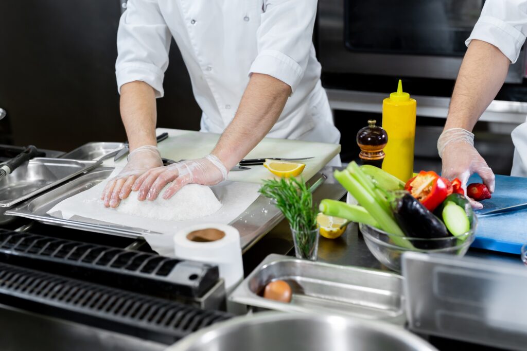 Chefs prepare meals in the kitchen.